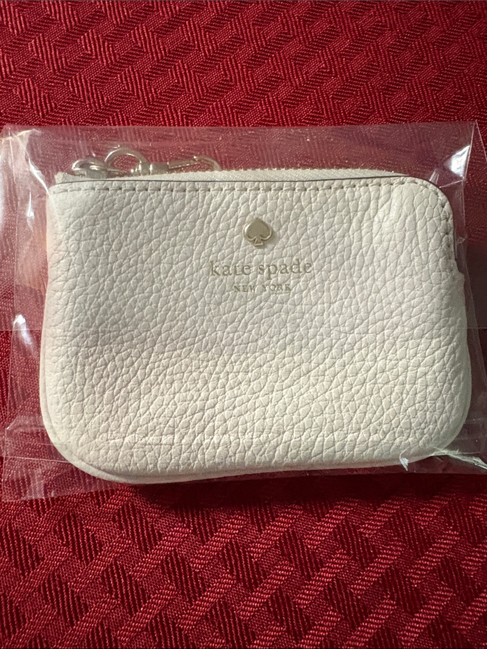 kate spade pebble leather coin pouch in ivory with gold logo